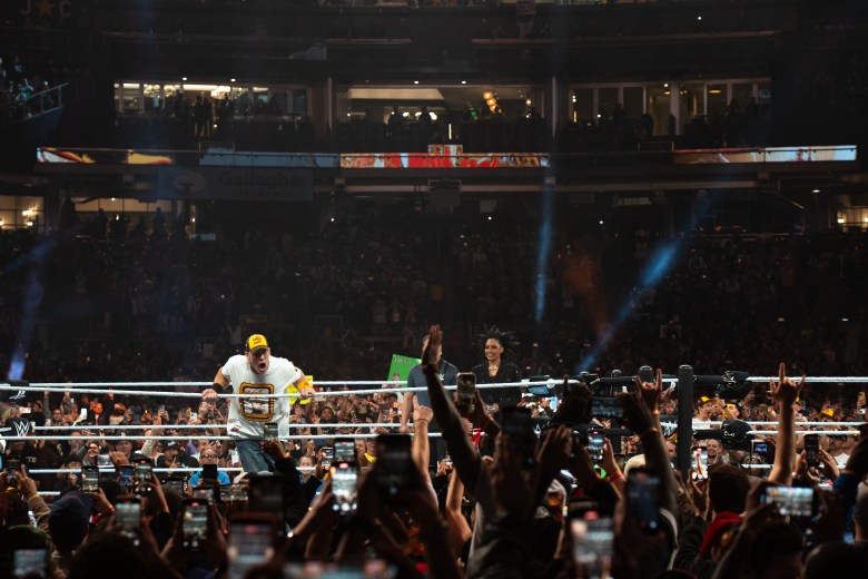 John Cena performs in Padres gear at the WWE Survivor Series against Dirty Dom Mysterio