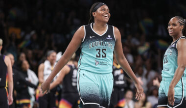 Aug 13, 2025; Las Vegas, Nevada, USA; Las Vegas Aces center A'ja Wilson (22) shoots against New York Liberty forward Kennedy Burke (22) and guard Natasha Cloud (9) during the second quarter of their game at Michelob Ultra Arena. Mandatory Credit: Candice Ward-Imagn Images