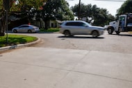 A new “cool pavement” (bottom) is seen on Ridgeside Drive as cars drive along Drujon Lane,...