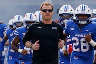 SMU head coach Rhett Lashlee and players run onto the field before an NCAA college football...