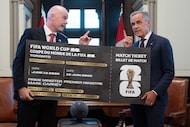 Canada Prime Minister Mark Carney, right, is presented with a novelty World Cup ticket by...