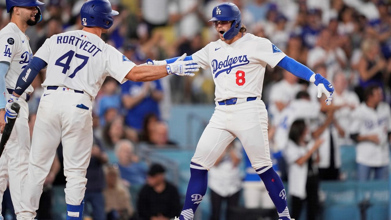 Los Angeles Dodgers' Kiké Hernandez (8) celebrates with teammates Ben Rortvedt (47) and Andy Pages after hitting a two-run home run during the second inning of a baseball game against the Philadelphia Phillies Tuesday, Sept. 16, 2025, in Los Angeles. (AP Photo/Mark J. Terrill)