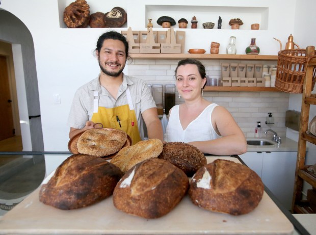 Arturo Enciso and Ana Salatino serve up fresh baked bread and other treats at Gusto Bread in Long Beach. (Photo by Tracey Roman, Contributing Photographer)