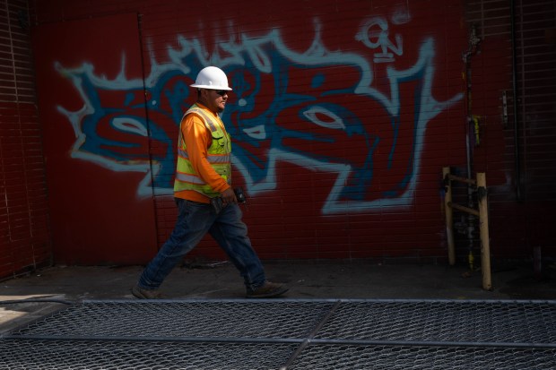 Luis Garcia, of Heritage 1976, works on demolishing a former...