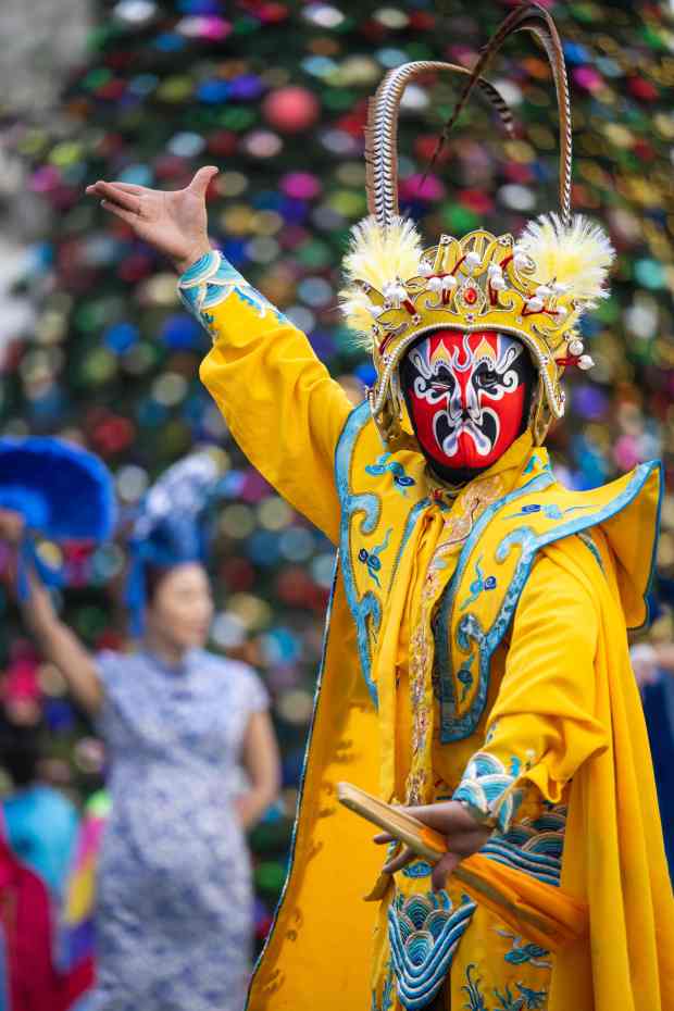 Ming performs the Chinese Face Changing Dance during a preview...