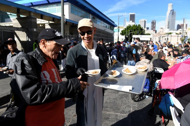 Philip Graulty helps serve food during the annual Los Angeles...