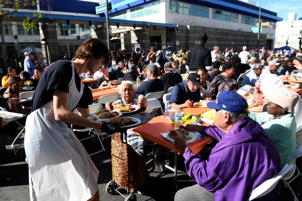 Jackson Boyd helps serve food during the annual Los Angeles...