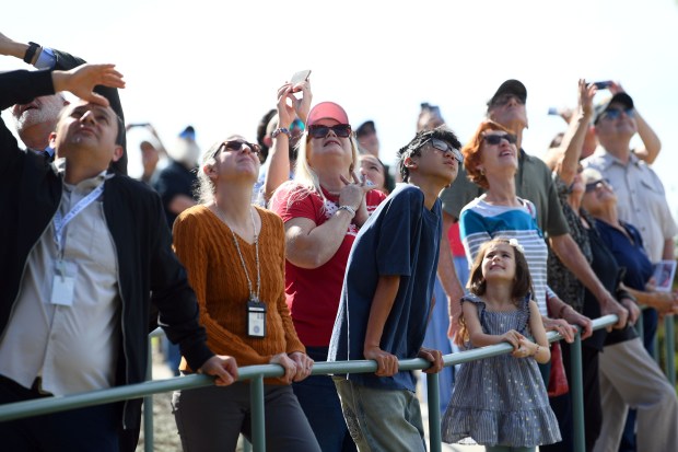 Visitors look to the sky as the Condor Squadron performs...