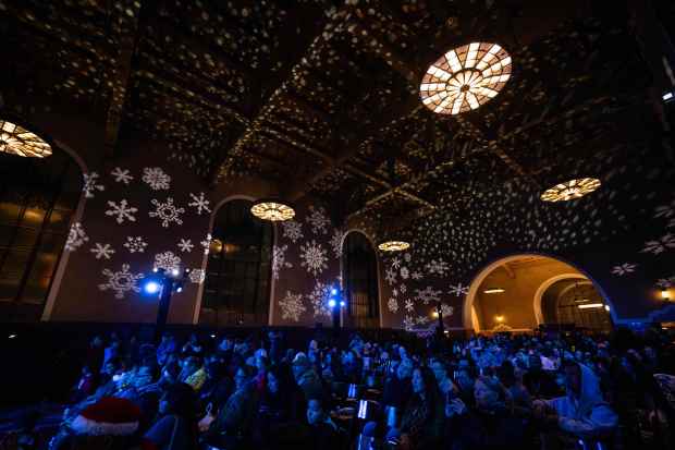 A crowd fills the ticket concourse of Los Angeles Union...