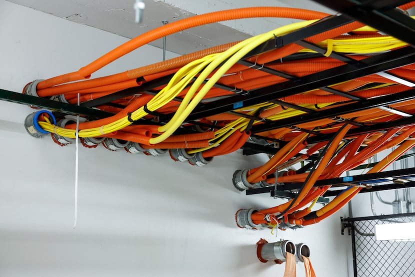 Various different fiber optic cables are seen entering into the DataBank data center,...