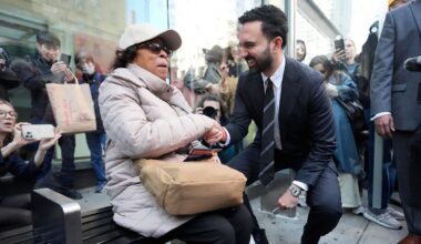 Then-mayoral candidate Zohran Mamdani speaks with a bus rider as she waits at a stop in the city on Monday, Oct. 27, 2025. (AP Photo/Seth Wenig)