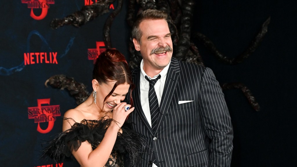 Millie Bobby Brown & David Harbour Hug On 'Stranger Things' Red Carpe
