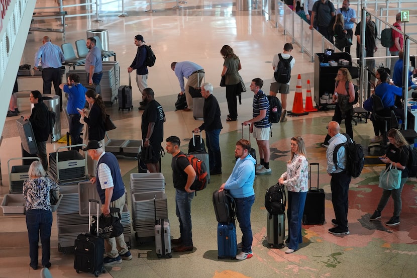 Travelers wait in line to clear security at Dallas Love Field Airport Thursday, Nov. 6,...