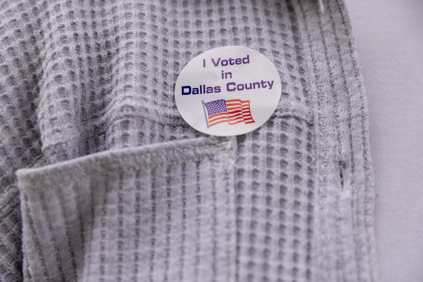 Rachel Mpala poses for a portrait after voting outside of the Oak Cliff Government Center in...