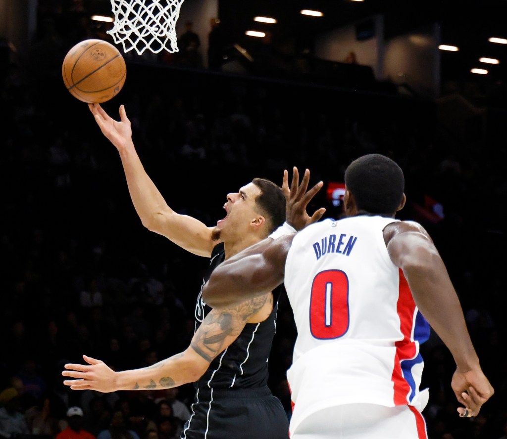 Brooklyn Nets forward Michael Porter Jr. puts up a shot past a defending Detroit Pistons center Jalen Duren (R) in the first half at the Barclays Center in Brooklyn, New York, November 07, 2025. 