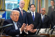 President Donald Trump answers questions from reporters during a meeting with the White...