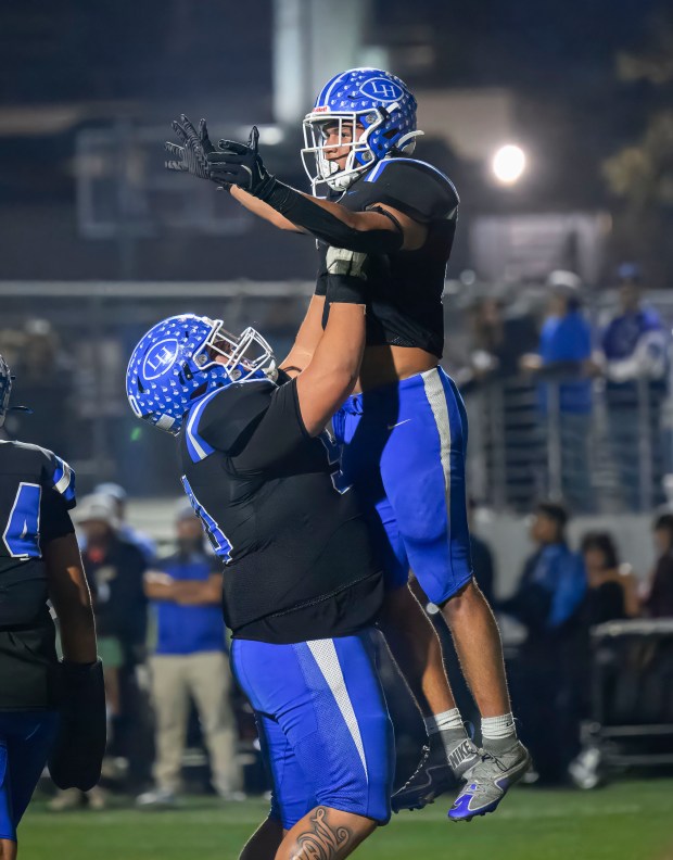 La Habra running back Kevika Mata’Utia- Martinez, right, gets a...