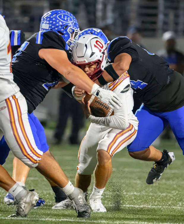El Modena quarterback Ethan Sorenson is sacked by La Habra...