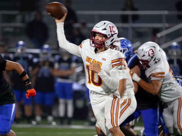 El Modena quarterback Ethan Sorenson scrambles to make a pass...