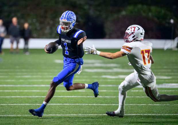 La Habra quarterback DJ Mitchell, left, scrambles away from El...
