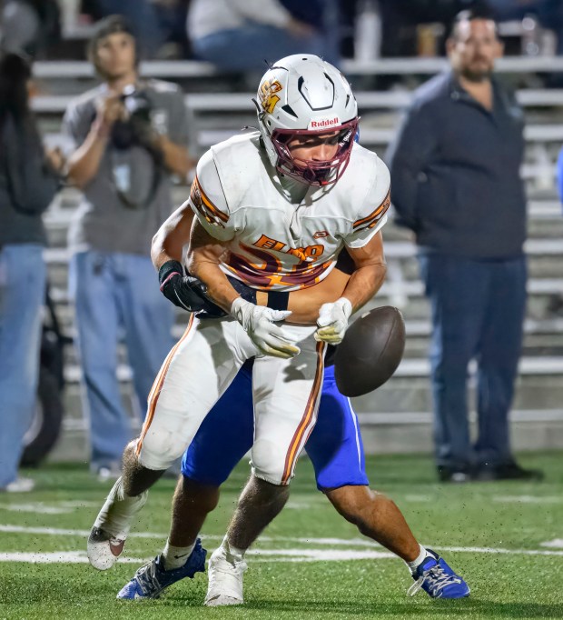 El Modena wide receiver Thomas Sheehan fumbles the ball as...