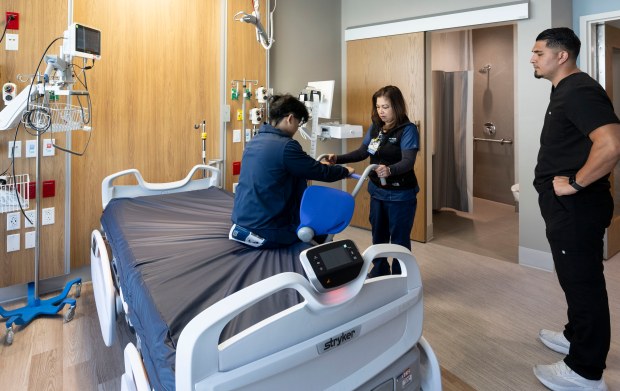 Registered nurses Catherine Durian and Alex Jefferson practice on a...