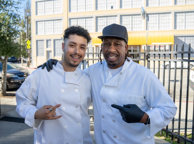 Chef Willie Waters and Micah Maldonado has there photo taken...
