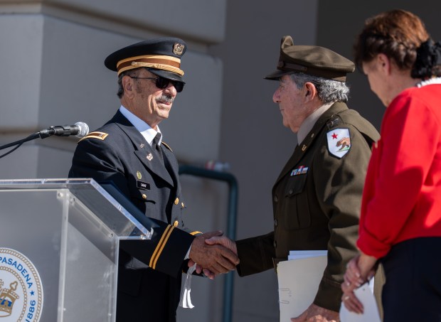 Ted Saraf shakes hands with William Paparian during the Veterans...