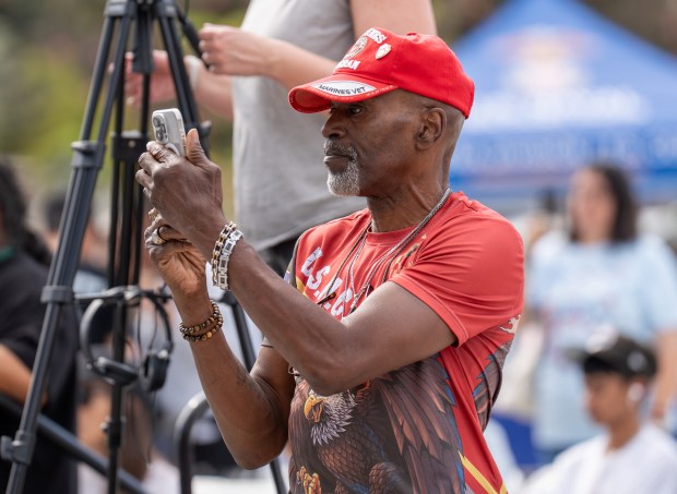 Marine Corps veteran Mark Downing takes a video during the...