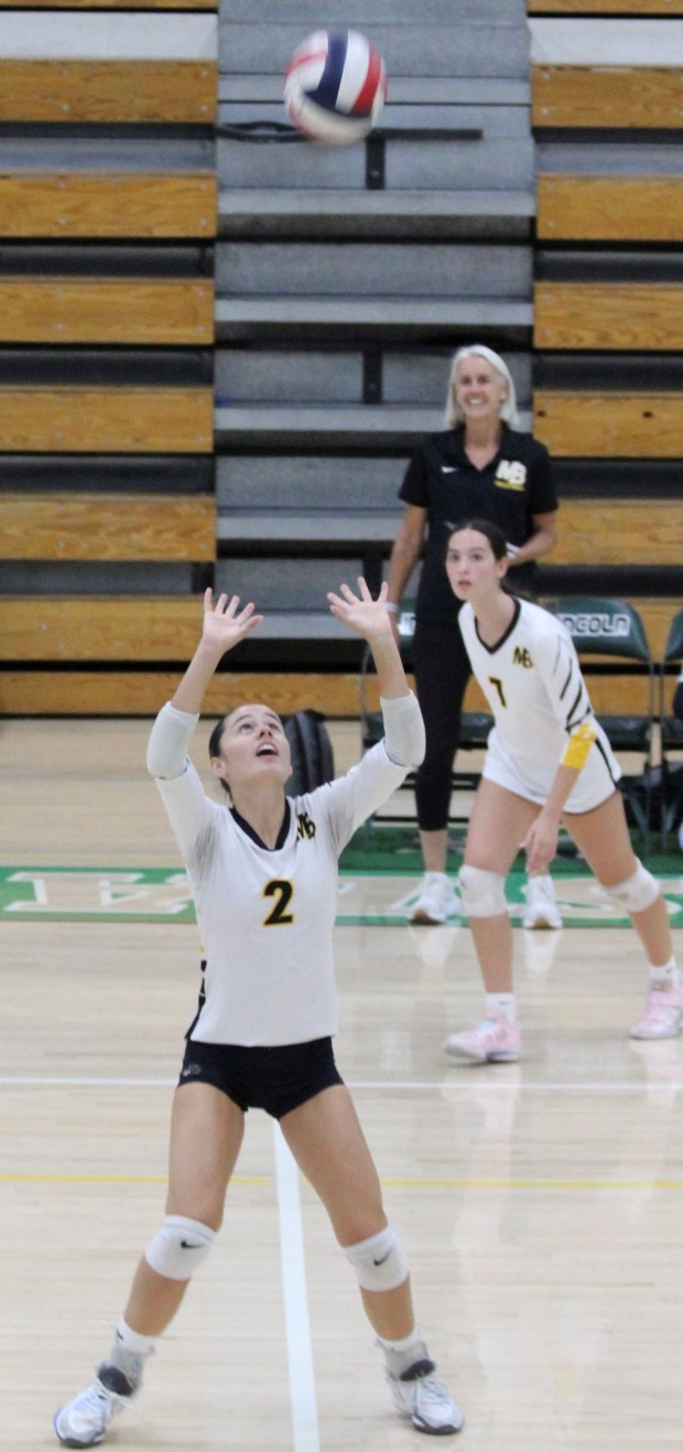Mission Bay High School senior #2, Gia Harder sets the ball during the Oct. 2 game against Lincoln High School. Focused on the play is #7 junior Aubrey Albarian, with Coach Barbara Birnbaum observing on the sidelines. (David Albarian)