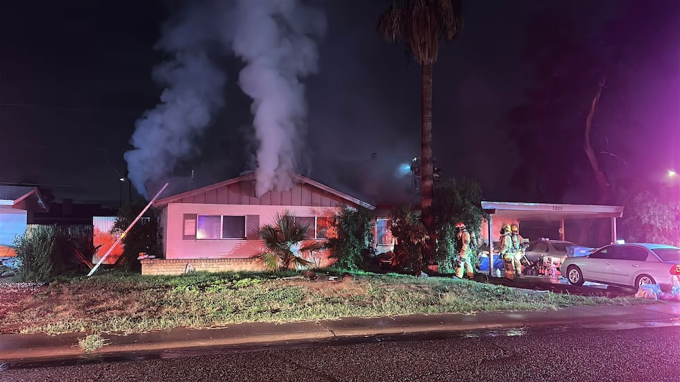 Firefighters battle a house fire near 32nd Street and Cactus Road in north Phoenix.