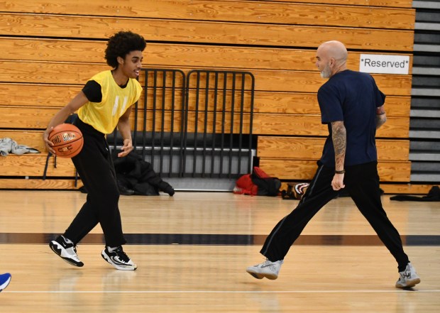 Roxborough High’s Nasir Middleton looks to take on Officer Ray...