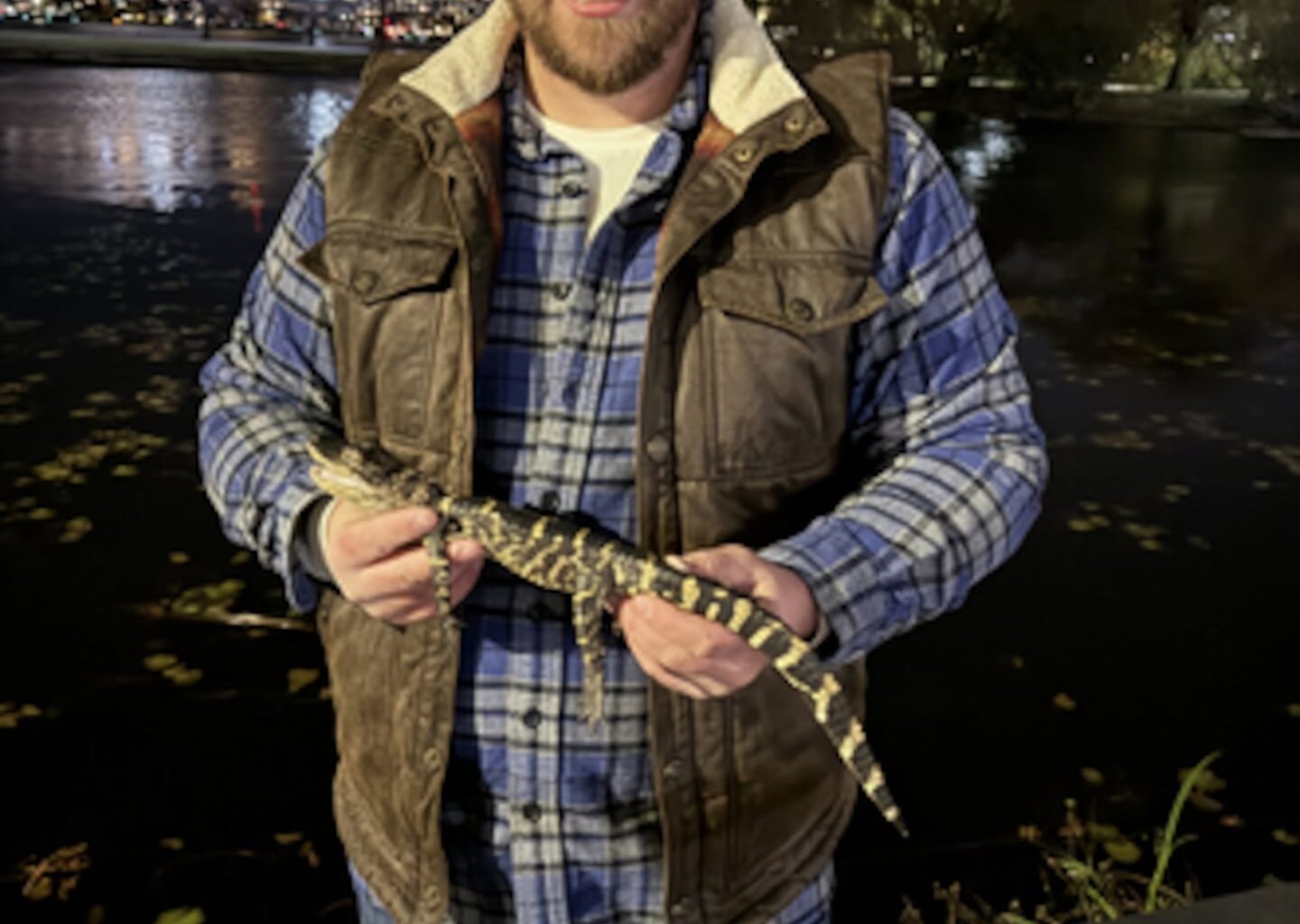A photo of Joe Kenney holding the alligator he rescued along the Charles River Wednesday night.