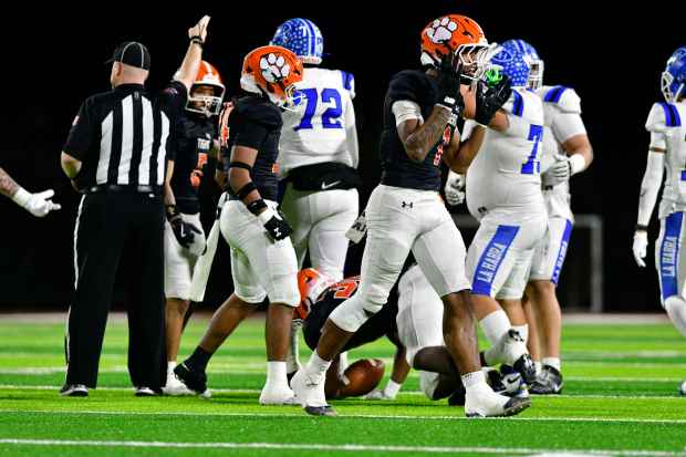 San Jacinto’s Jeremiah Brown celebrates after the Tigers picked up...