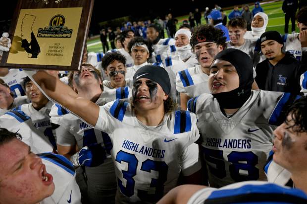 La Habra’s Noah Barajas lifts the CIF title plaque after...
