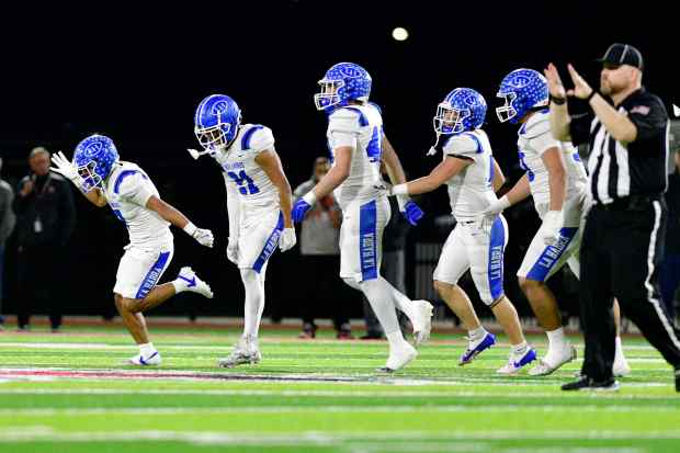 La Habra’s Aaron Castro, far left, leads the Highlanders defense...