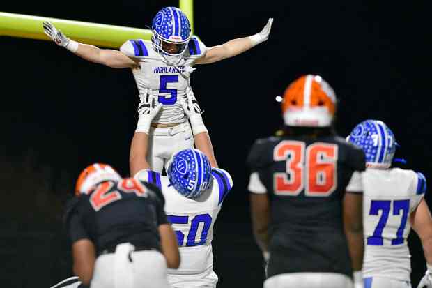 La Habra’s Jacob Morales lifts Bobby Brooks into the air...