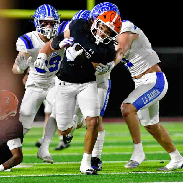 San Jacinto’s Daron Love running through La Habra’s defense during...