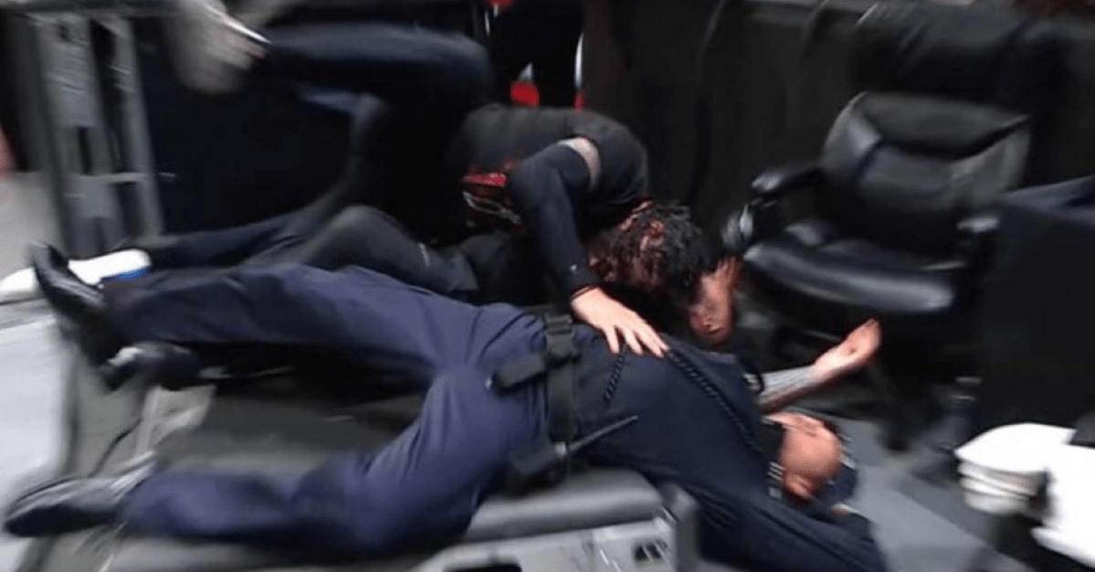 Roman Reigns is out here spearing cops on Raw