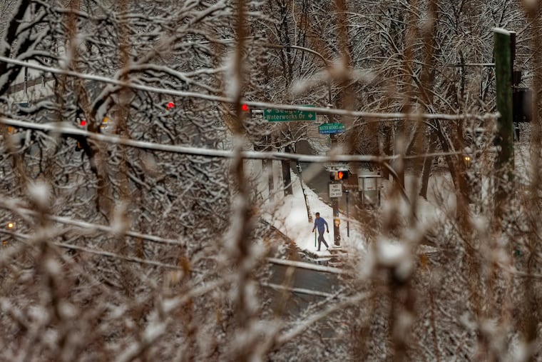 Early morning runner along Kelly Drive and Water Works Drive after an overnight snow fall, Philadelphia, Wednesday morning Feb. 12, 2025.