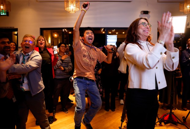 Measure A volunteer Lawrence Deng, center, and Santa Clara County...