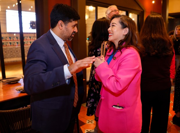 Santa Clara County Executive James Williams, left, chats with Santa...