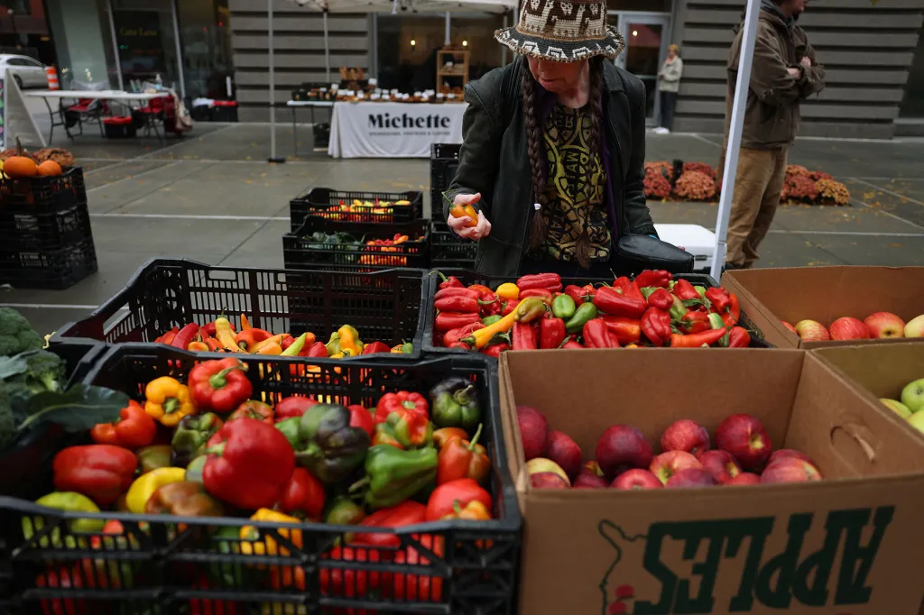 A customer shops for produce at a Boston farmers market.
