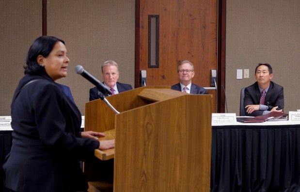 10/30/2025_OCEANSIDE, CA_The first community forum on the Sharp HealthCare and Tri-City Medical Center affiliation agreement at the Tri-City board meeting room- Tri-City hospital nurse Elisa Romero, who was born at the hospital, has positive things to say about it at the meeting. Listening are, LtoR: Sharp HealthCare Chief Strategy Officer Scott Evans, Sharp HealthCare CEO Chris Howard, and Dr. Gene Ma, Tri-City Health Care District CEO. (Charlie Neuman / For The San Diego Union-Tribune)