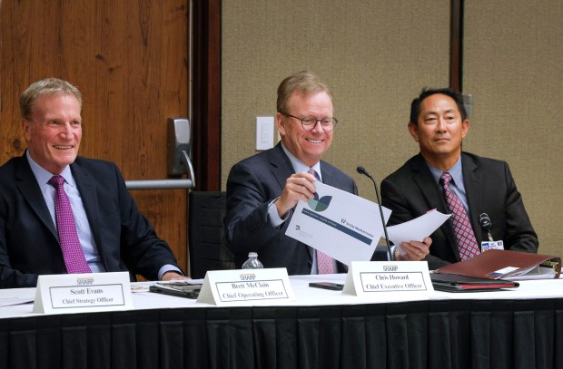 10/30/2025_OCEANSIDE, CA_The first community forum on the Sharp HealthCare and Tri-City Medical Center affiliation agreement at the Tri-City board meeting room- Listening to positive comments about the agreement from an audience member are, LtoR: Sharp HealthCare Chief Strategy Officer Scott Evans, Sharp HealthCare CEO Chris Howard, and Dr. Gene Ma, Tri-City Health Care District CEO. (Charlie Neuman / For The San Diego Union-Tribune)