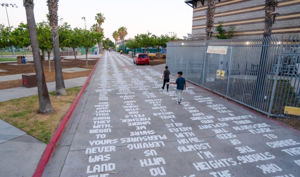 "Memoria Terra" (2024) is a public art project behind the City Heights LIbrary in which 2,000-word poems by five CIty Heights youth fill the pedestrian-only street. (Shinpei Takeda / The AJA Project)