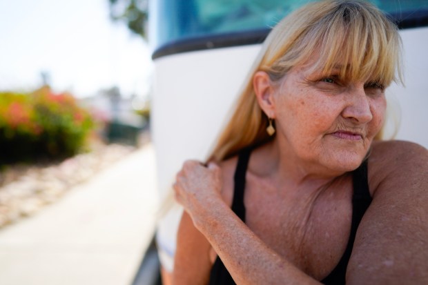 On Friday, Oct. 31, 2025, in San Diego, Teresa Lunsford, 66, who medically retired 10 years ago, stands next to her 32-foot RV she's called home. (Nelvin C. Cepeda / The San Diego Union-Tribune)