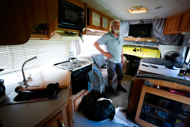 Standing in his 32-foot RV, Kevin Denczek, 67, tries to figure out how he's going to make it until his November paycheck. Denczek spent the majority of his October food budget on his last parking citation.  For more than a year, he has been living out of an RV and must relocate to different parking spots every 72 hours. (Nelvin C. Cepeda / The San Diego Union-Tribune)