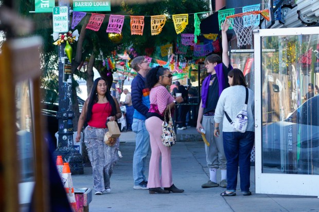 Customers walked abut Barrio Logan during Small Business Saturday. (Nelvin C. Cepeda / The San Diego Union-Tribune)