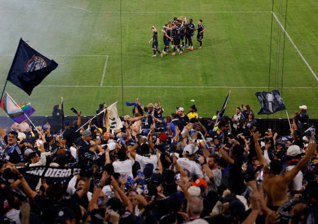Anders Dreyer #10 of San Diego FC, left, and fans celebrate after scoring a goal against the Portland Timbers during match three of the Western Conference Round One of the 2025 MLS Cup Playoffs at Snapdragon Stadium on Nov. 9, 2025 in San Diego, California. (K.C. Alfred / The San Diego Union-Tribune)